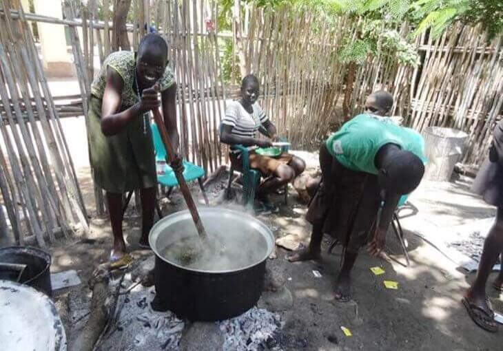 South Sudan woman stirring pot