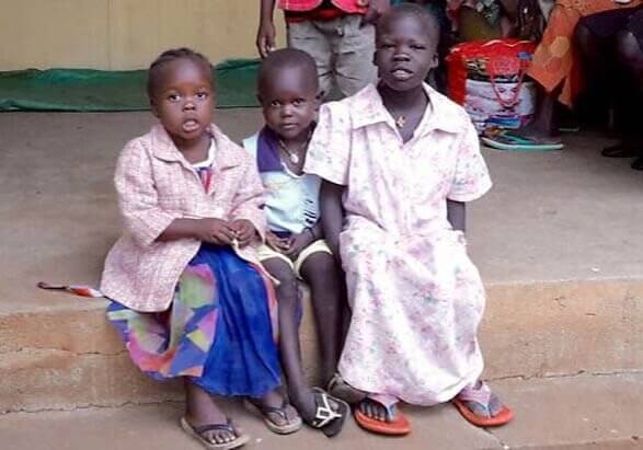 South Sudanese sitting on porch step